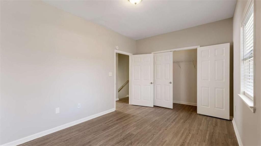 848 Ridge Avenue Northwest, Unit A Atlanta, GA 30318 - Photo 16 of 26 a view of an empty room with wooden floor and a window