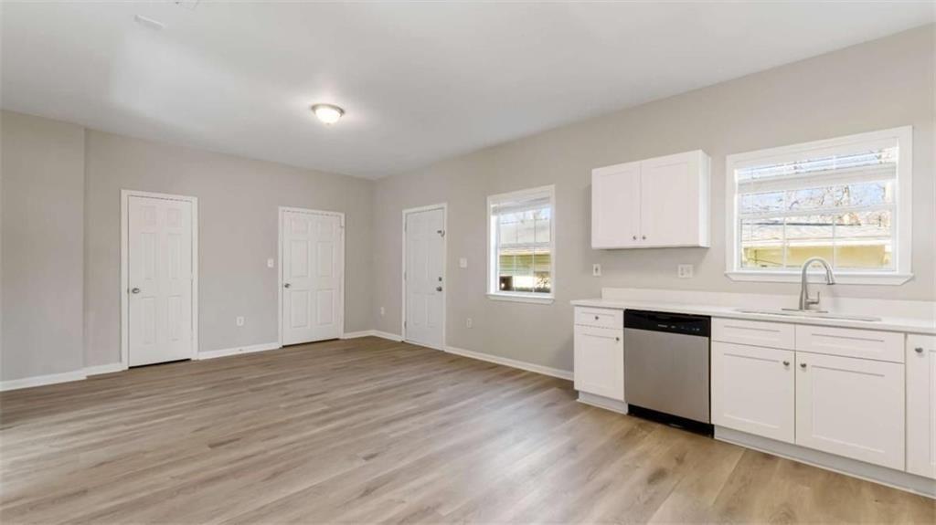 848 Ridge Avenue Northwest, Unit A Atlanta, GA 30318 - Photo 7 of 26 a view of a kitchen with a sink dishwasher and wooden floor