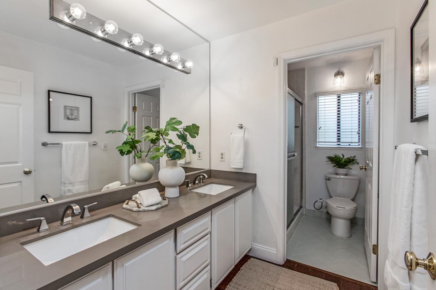 2080 Marich Way, Unit 8 Mountain View, CA 94040 - Photo 14 of 23 a bathroom with a granite countertop sink a toilet and a mirror