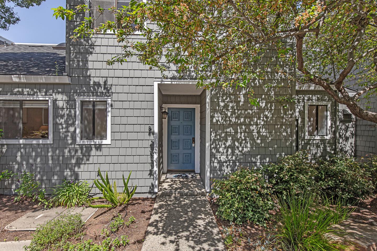 2080 Marich Way, Unit 8 Mountain View, CA 94040 - Photo 2 of 23 a brick building with a tree in front