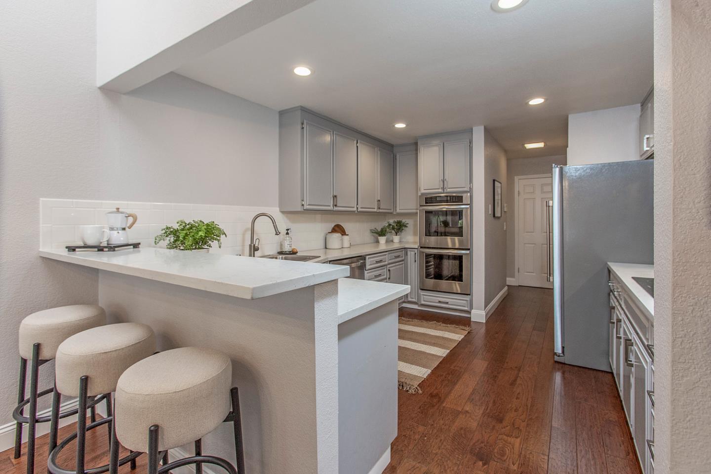2080 Marich Way, Unit 8 Mountain View, CA 94040 - Photo 7 of 23 a kitchen with a sink cabinets and wooden floor