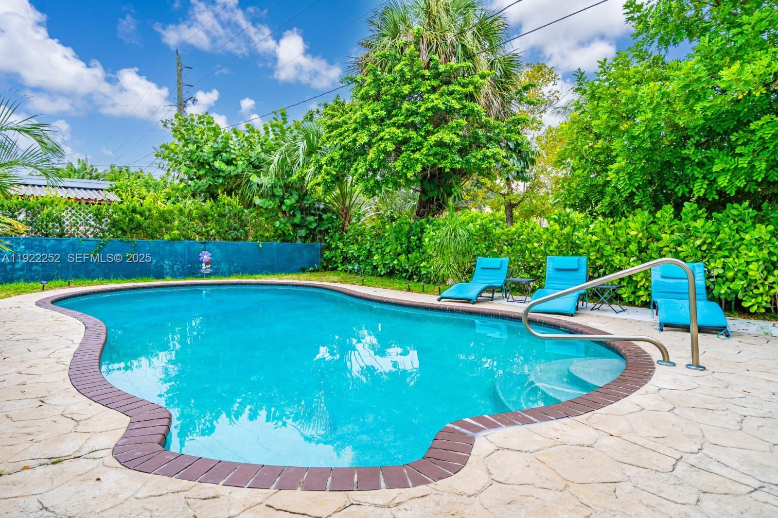 1165 Southwest 4th Terrace Pompano Beach, FL 33060 - Photo 12 of 42 a view of a swimming pool with a patio