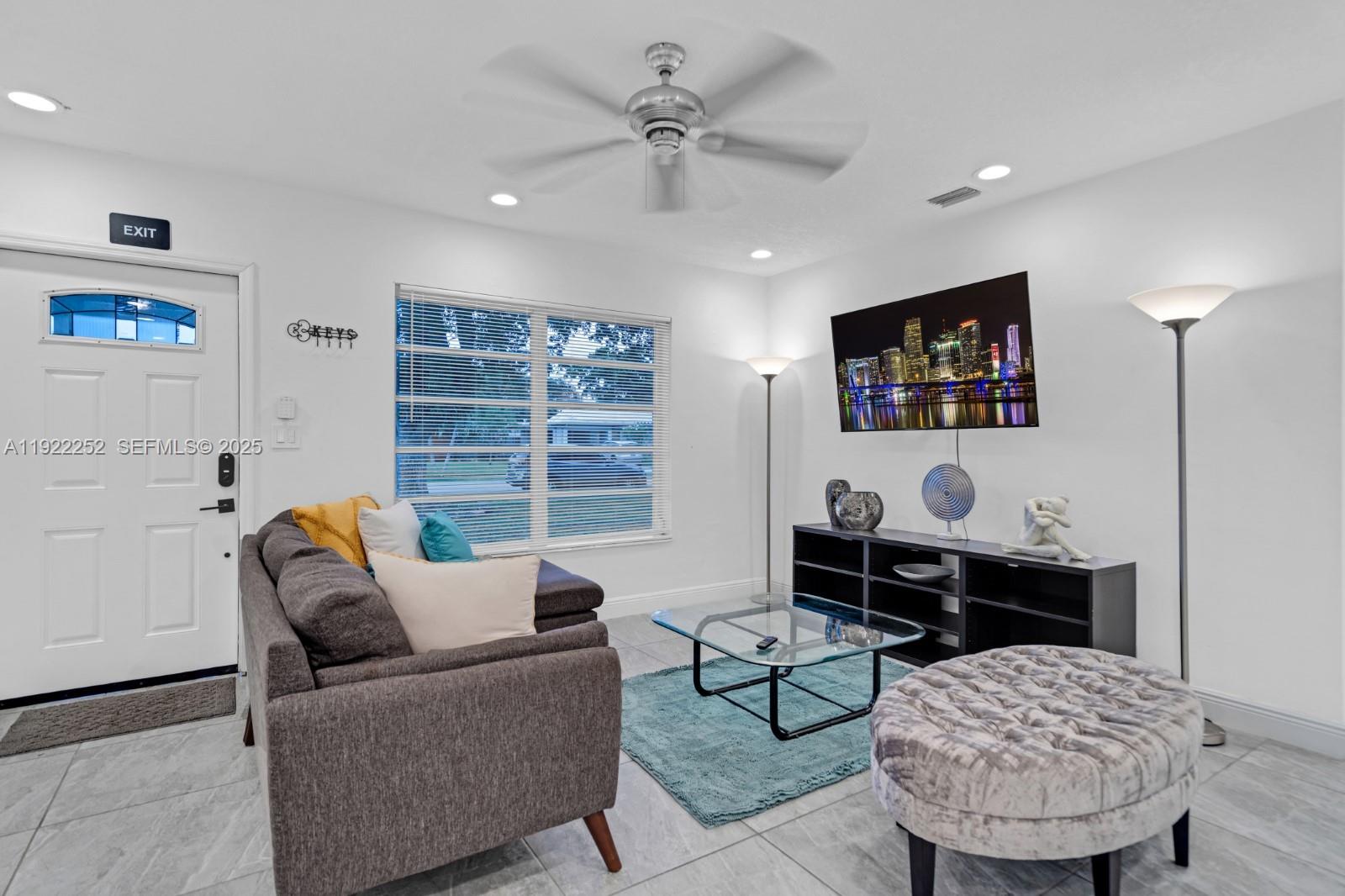 1165 Southwest 4th Terrace Pompano Beach, FL 33060 - Photo 20 of 42 a living room with furniture a ceiling fan and a window