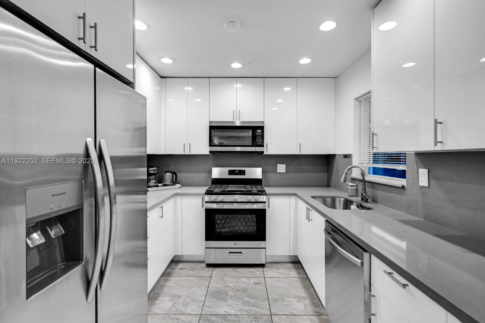 1165 Southwest 4th Terrace Pompano Beach, FL 33060 - Photo 21 of 42 a kitchen with a sink stainless steel appliances and cabinets