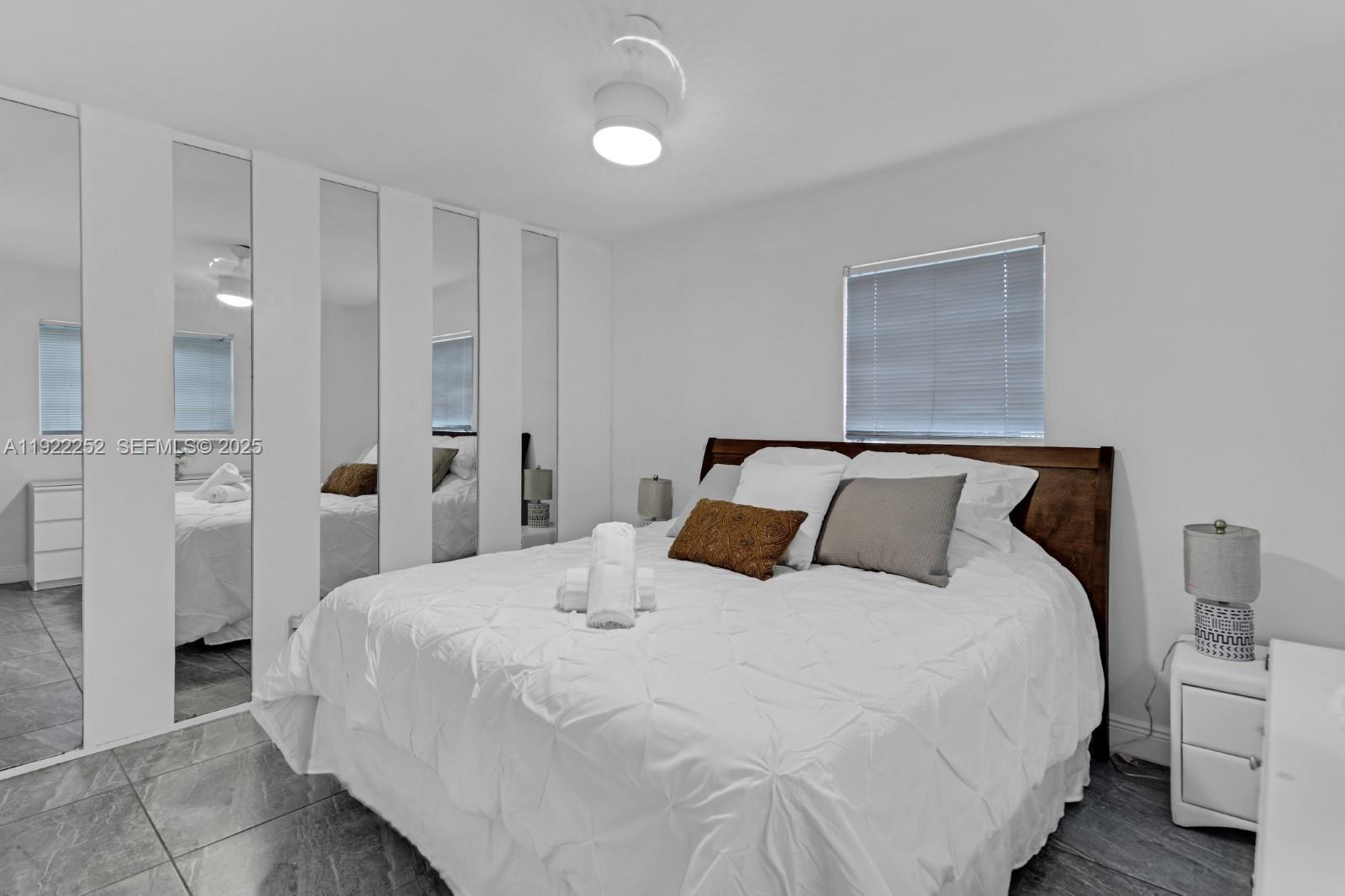 1165 Southwest 4th Terrace Pompano Beach, FL 33060 - Photo 23 of 42 a bedroom with a bed and closet with wooden floor