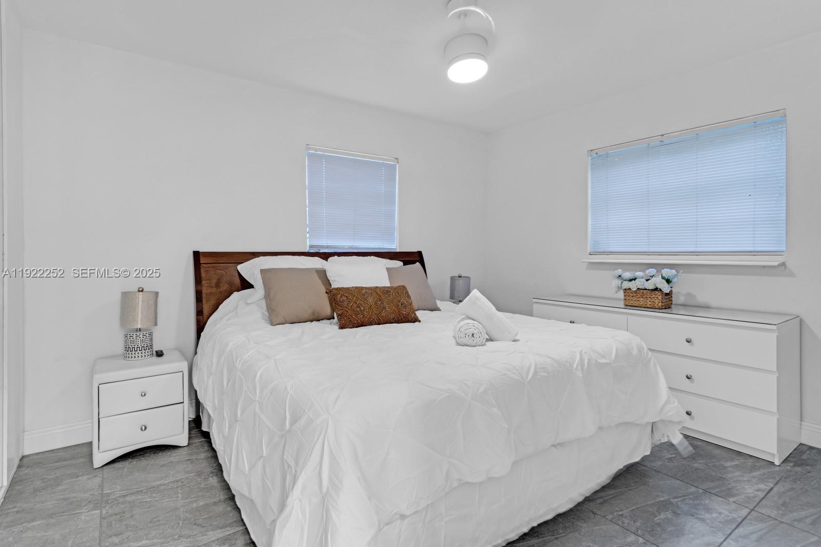 1165 Southwest 4th Terrace Pompano Beach, FL 33060 - Photo 24 of 42 a bedroom with a bed and a night stand