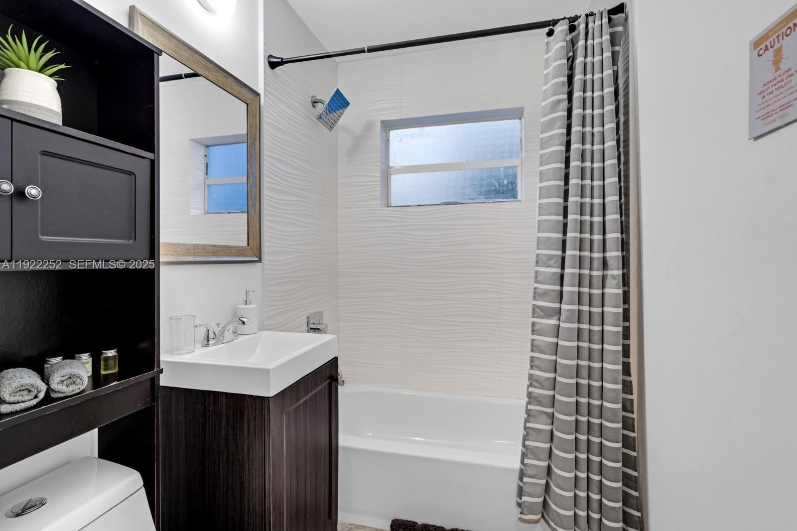 1165 Southwest 4th Terrace Pompano Beach, FL 33060 - Photo 29 of 42 a bathroom with a sink a toilet and shower