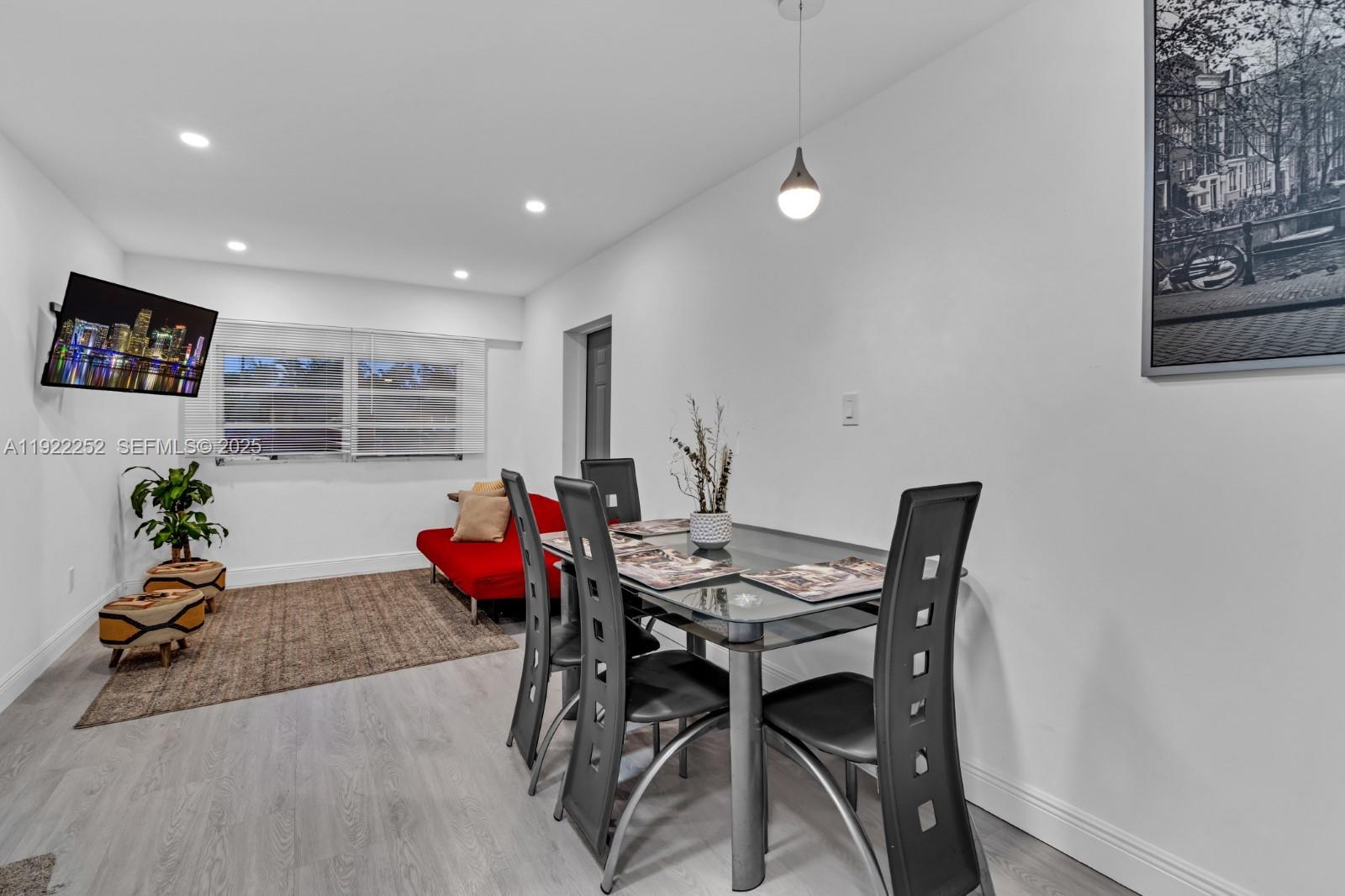 1165 Southwest 4th Terrace Pompano Beach, FL 33060 - Photo 32 of 42 a dining room with furniture and wooden floor