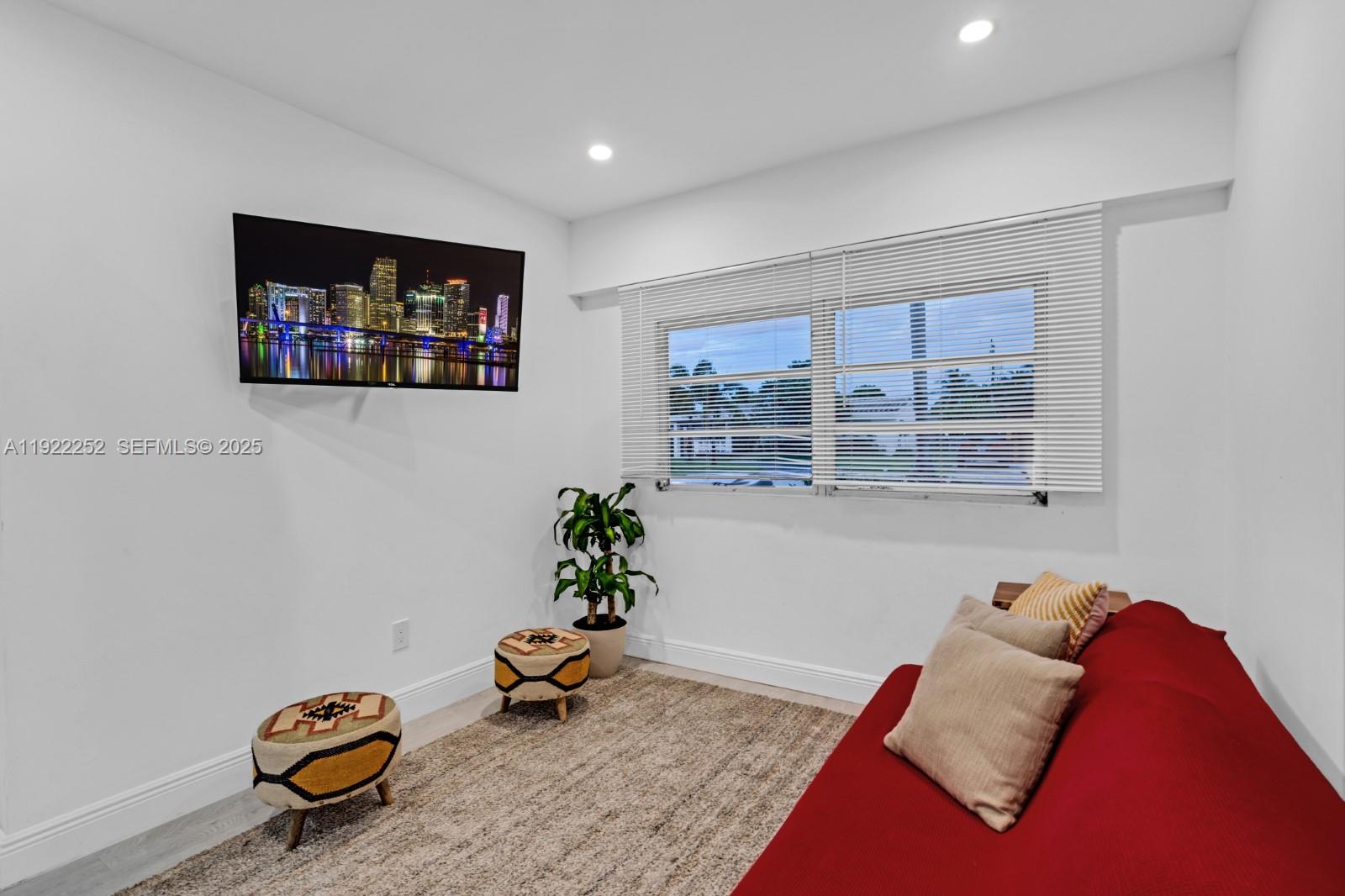 1165 Southwest 4th Terrace Pompano Beach, FL 33060 - Photo 34 of 42 a living room with a couch and a potted plant