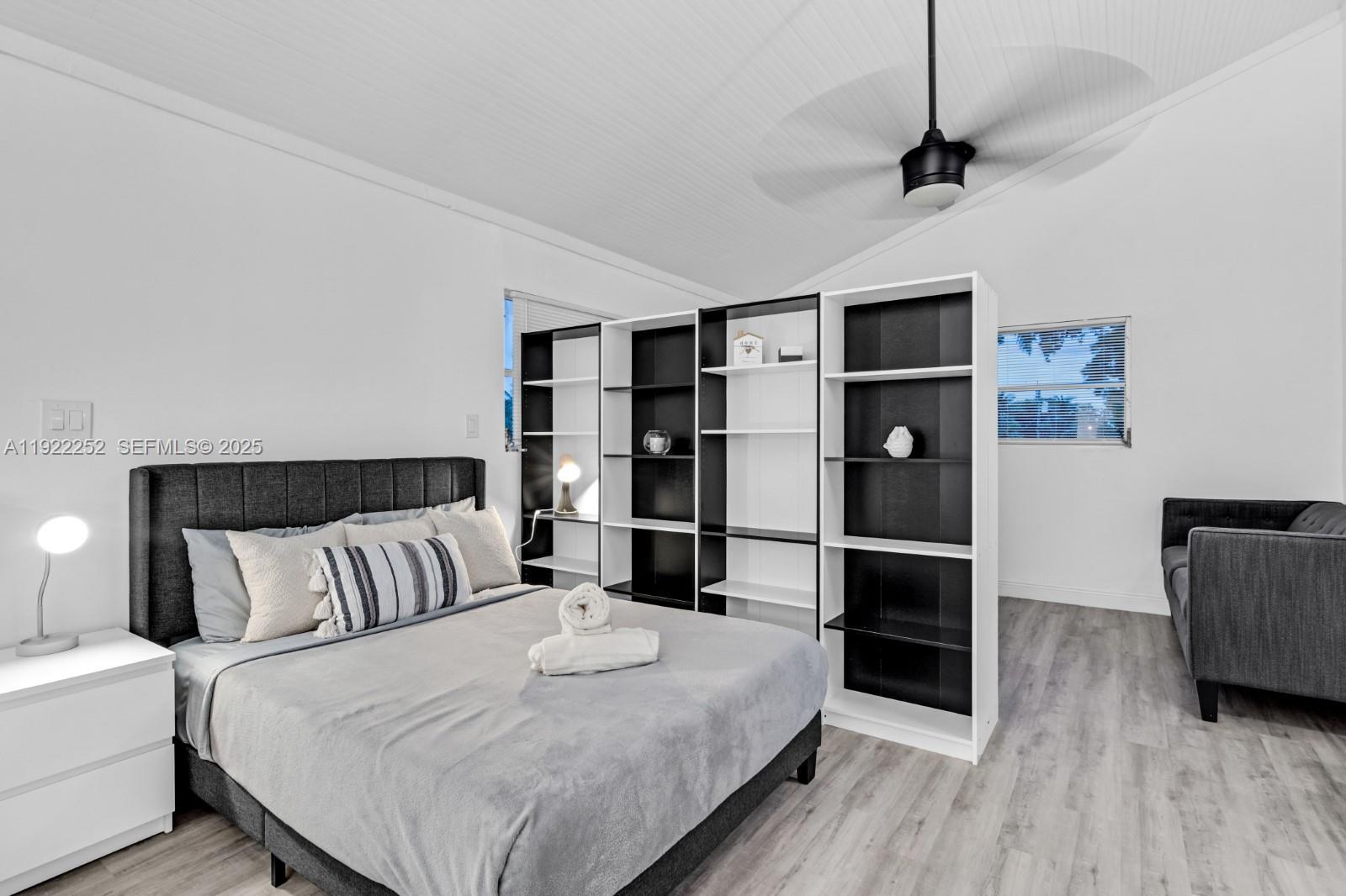 1165 Southwest 4th Terrace Pompano Beach, FL 33060 - Photo 37 of 42 a bedroom with a bed and a bookshelf