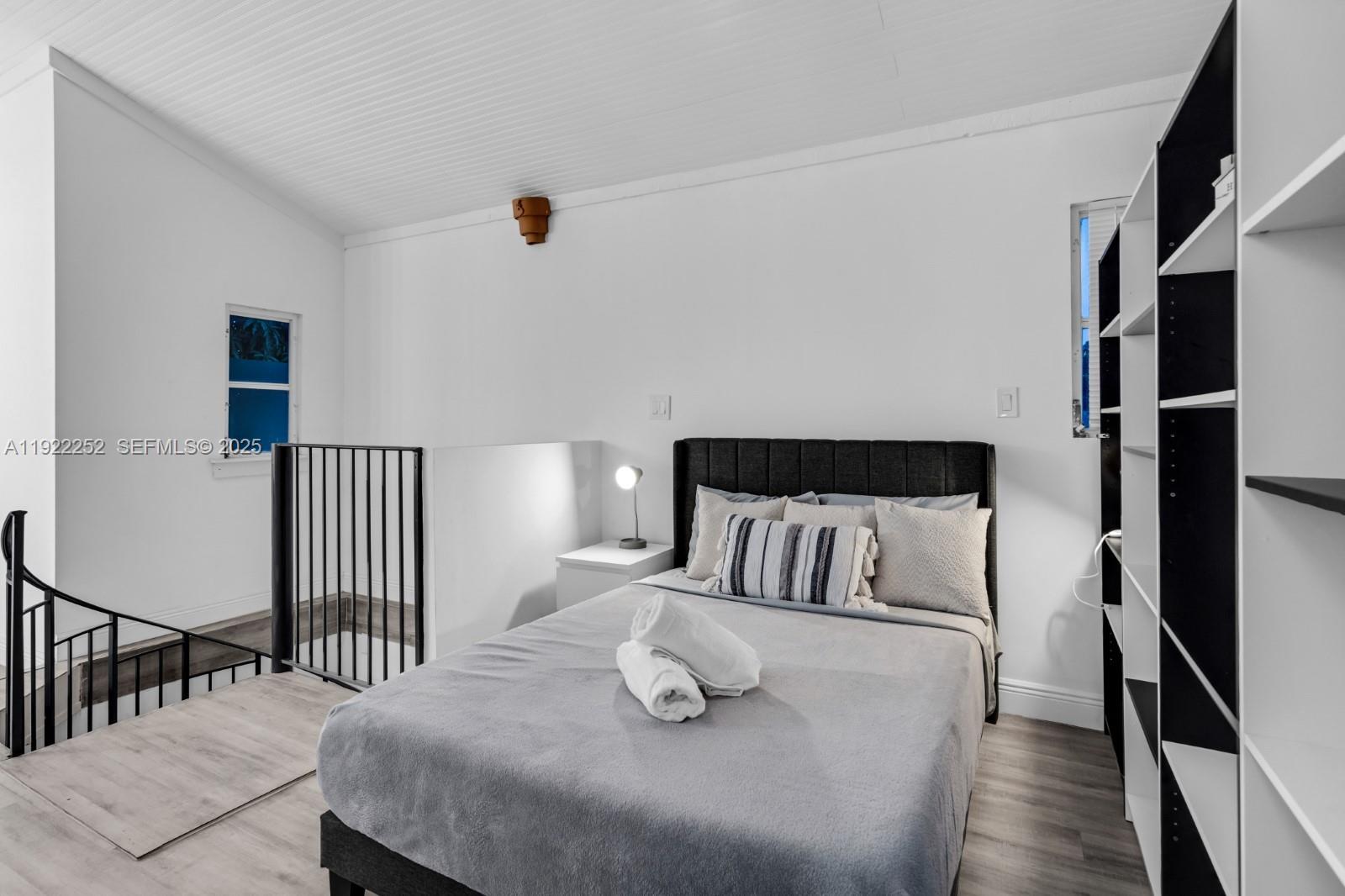 1165 Southwest 4th Terrace Pompano Beach, FL 33060 - Photo 39 of 42 a bedroom with a bed and wooden floor