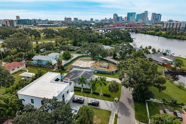 an aerial view of a house with a yard and lake view