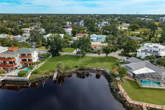an aerial view of residential houses with outdoor space and swimming pool