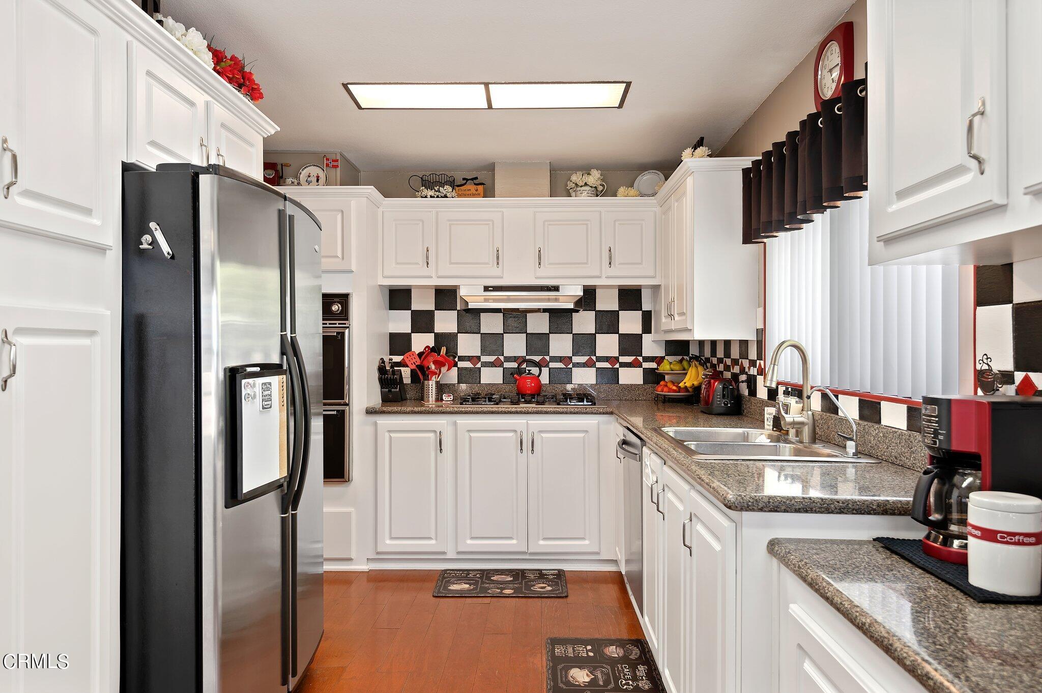 520 Raspberry Place, Unit 35 Oxnard, CA 93036 - Photo 8 of 27 a kitchen with stainless steel appliances granite countertop a refrigerator and a sink