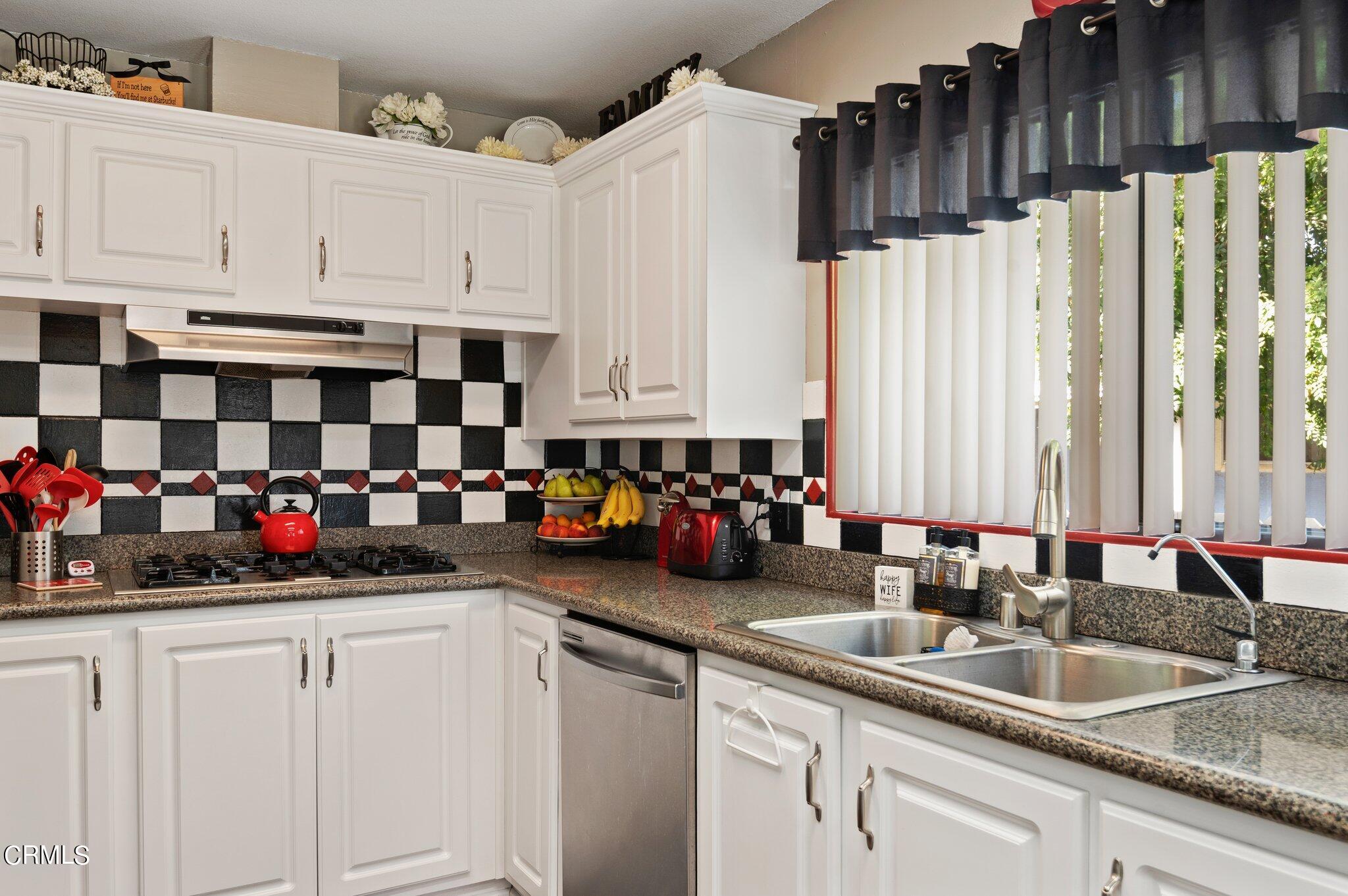520 Raspberry Place, Unit 35 Oxnard, CA 93036 - Photo 9 of 27 a kitchen with sink a cabinets and window