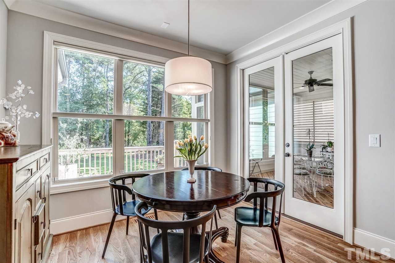 14010 Durant Road Raleigh, NC 27614 - Photo 16 of 30 a dining room with furniture window and wooden floor