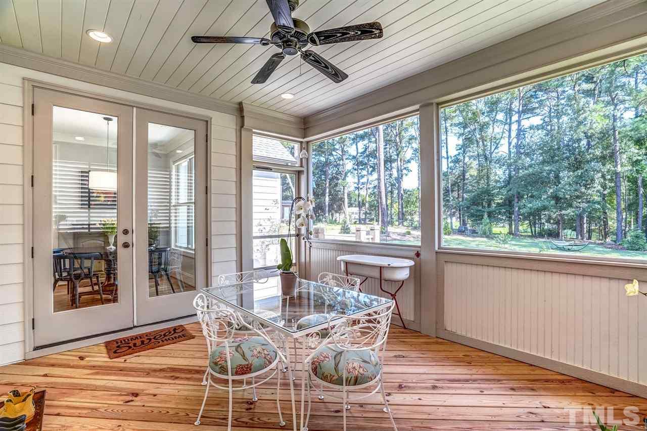 14010 Durant Road Raleigh, NC 27614 - Photo 17 of 30 a dining room with wooden floor glass table and chairs