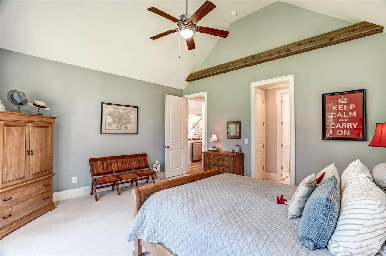 14010 Durant Road Raleigh, NC 27614 - Photo 20 of 30 a bed room with a bed and a chandelier