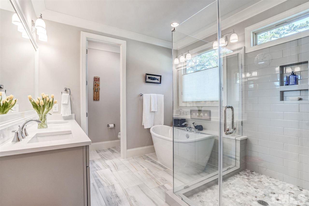 14010 Durant Road Raleigh, NC 27614 - Photo 21 of 30 a bathroom with a sink a mirror and a shower