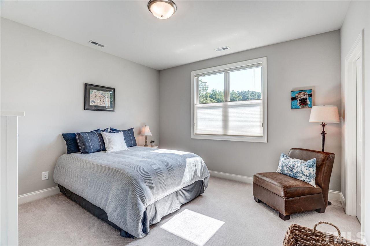 14010 Durant Road Raleigh, NC 27614 - Photo 22 of 30 a bedroom with bed couch and window