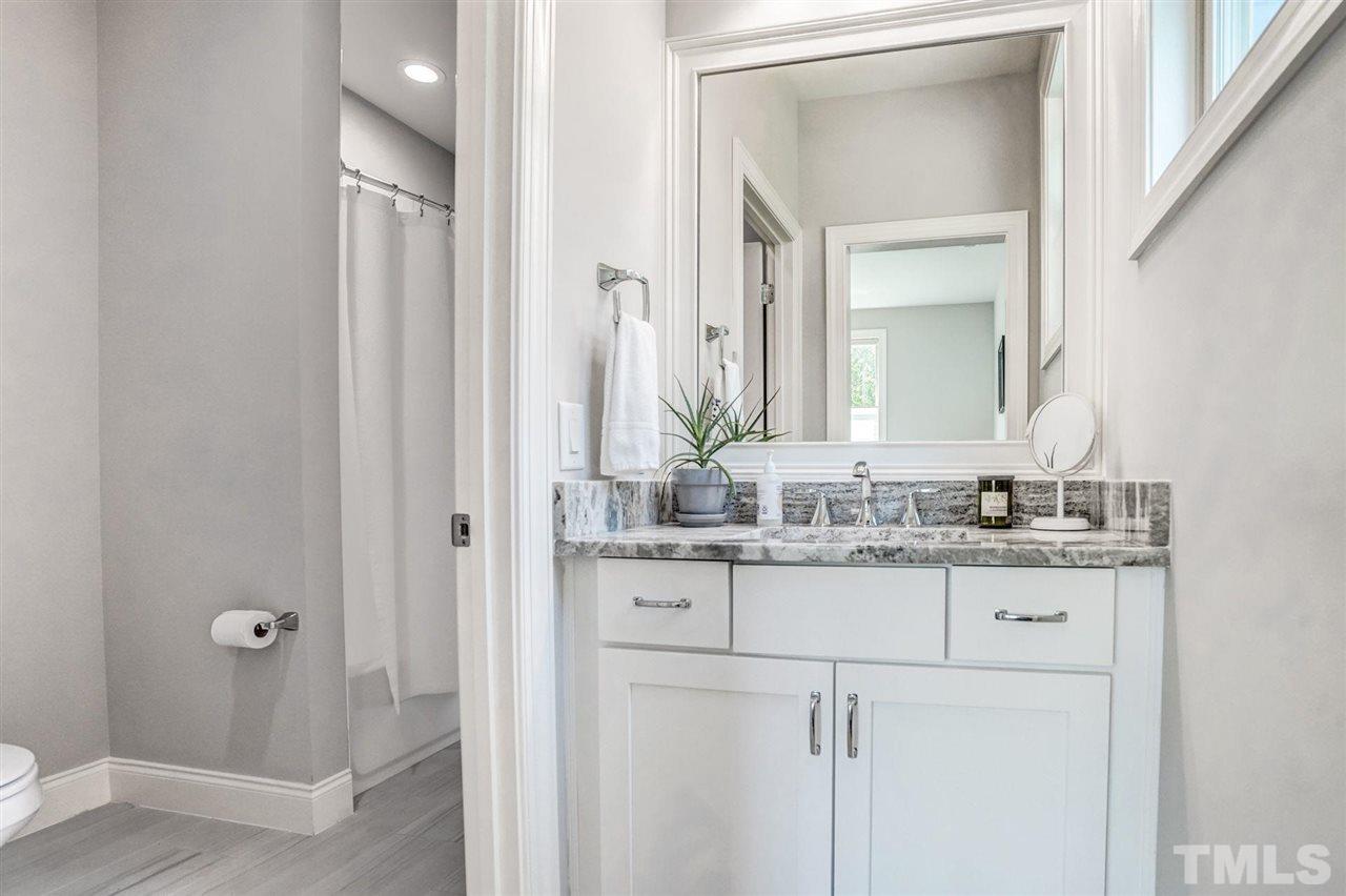 14010 Durant Road Raleigh, NC 27614 - Photo 25 of 30 a bathroom with a granite countertop sink and a mirror