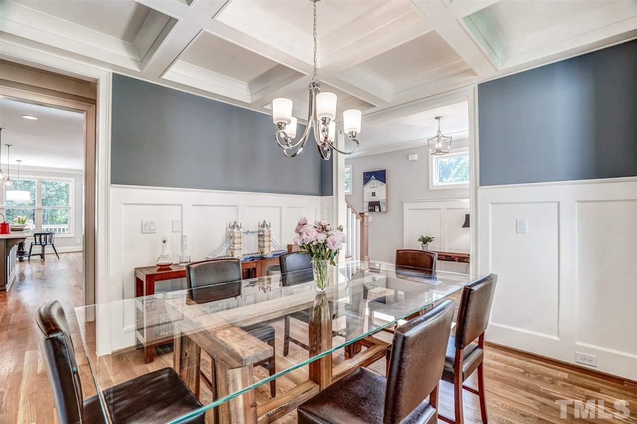 14010 Durant Road Raleigh, NC 27614 - Photo 7 of 30 a view of a dining room with furniture a chandelier and wooden floor