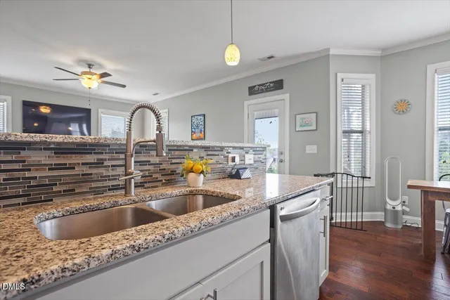 a view of a big room with wooden floor and a kitchen
