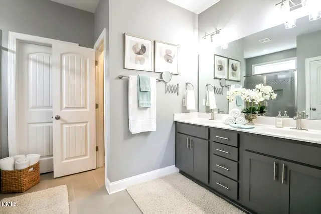 a bathroom with a sink double vanity and a mirror