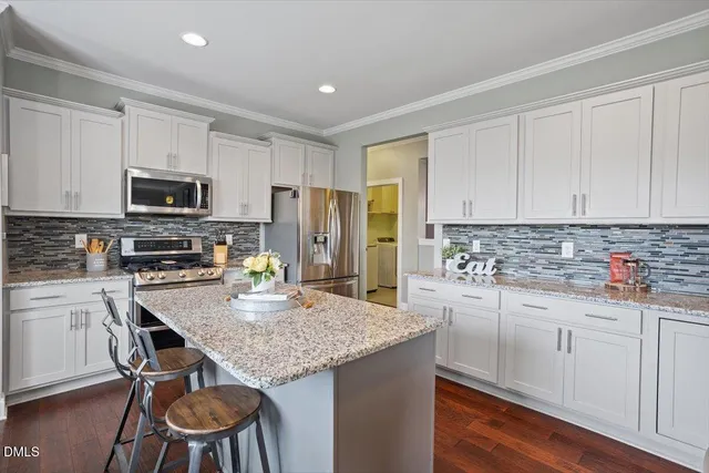 a kitchen with sink stove and cabinets