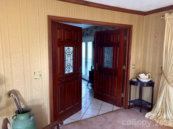 a kitchen with stainless steel appliances kitchen island granite countertop a sink dishwasher and a black refrigerator