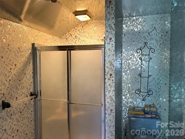 a bedroom with furniture and a large window