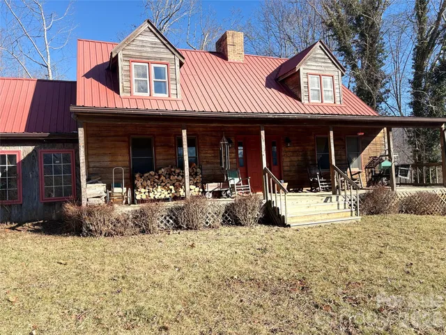 a view of a house with floor to ceiling windows and a basket ball poll
