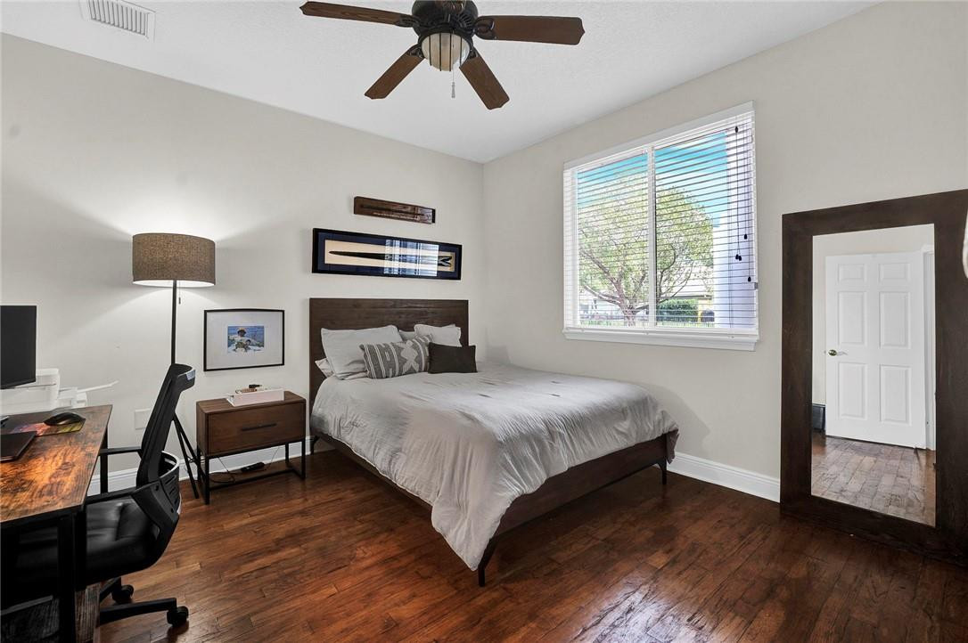 20240 Southwest 51st Court Southwest Ranches, FL 33332 - Photo 24 of 60 a bedroom with a bed and wooden floor