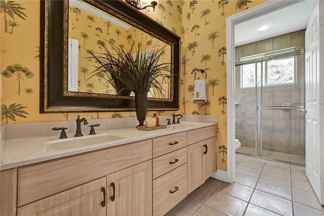 20240 Southwest 51st Court Southwest Ranches, FL 33332 - Photo 25 of 60 a bathroom with a double vanity sink mirror and a shower