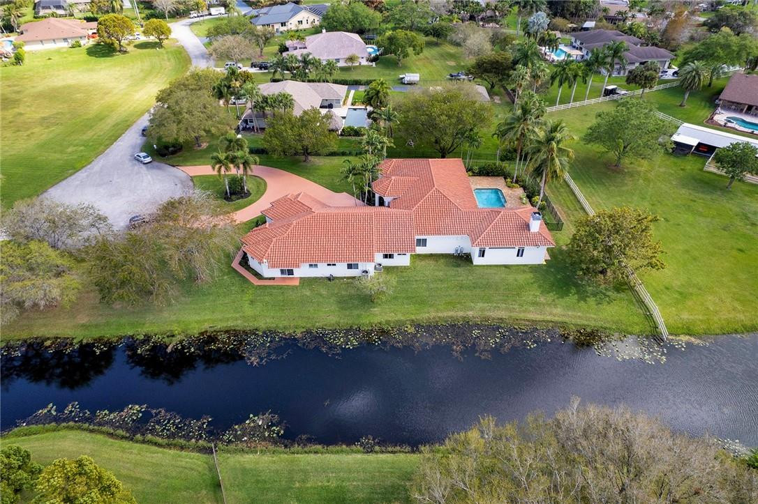 20240 Southwest 51st Court Southwest Ranches, FL 33332 - Photo 5 of 60 an aerial view of residential house with outdoor space