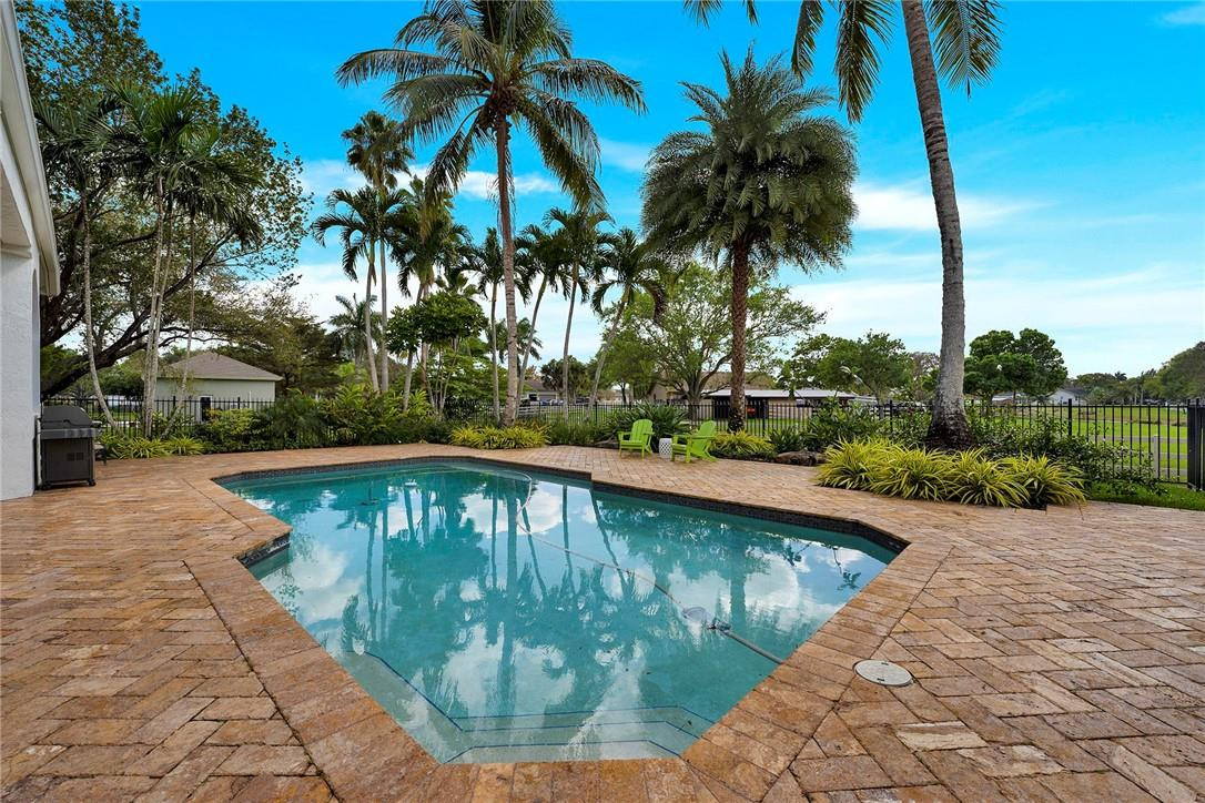 20240 Southwest 51st Court Southwest Ranches, FL 33332 - Photo 53 of 60 a view of swimming pool with a garden