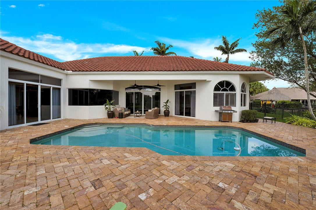20240 Southwest 51st Court Southwest Ranches, FL 33332 - Photo 54 of 60 a view of a house with swimming pool and a porch