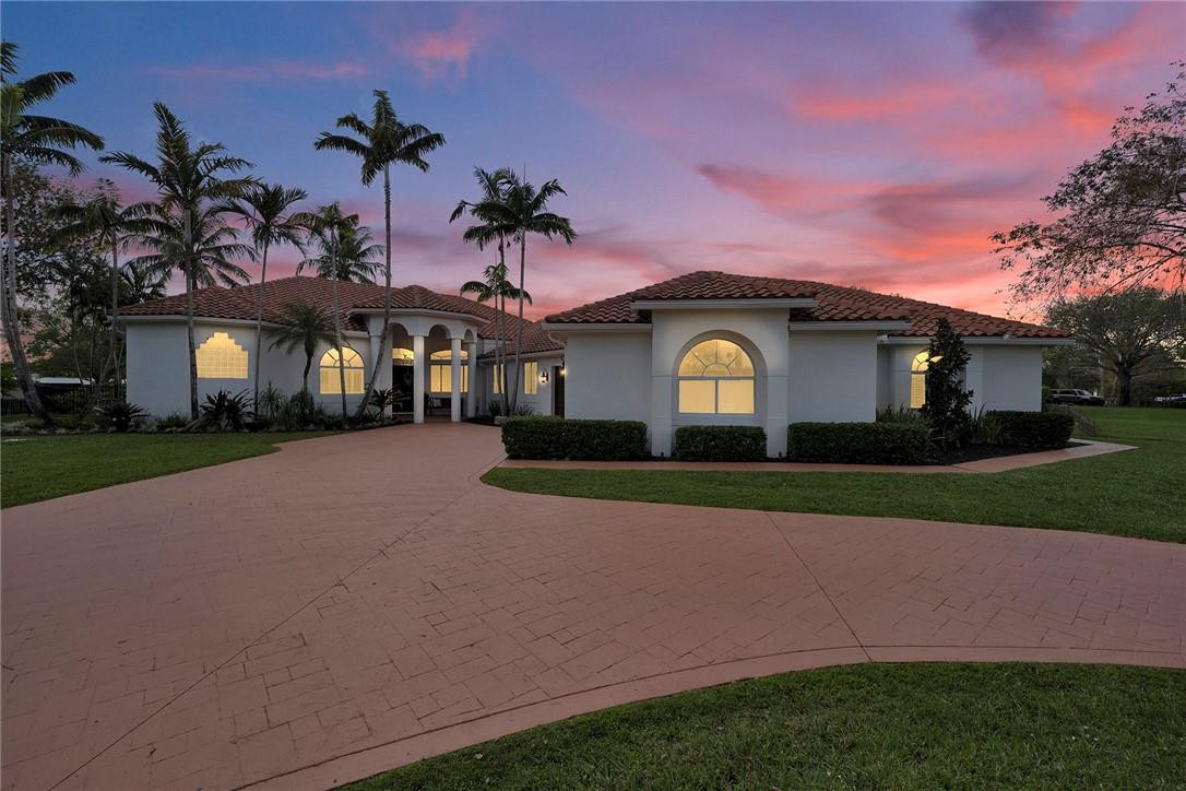 20240 Southwest 51st Court Southwest Ranches, FL 33332 - Photo 59 of 60 a front view of a house with a garden and yard
