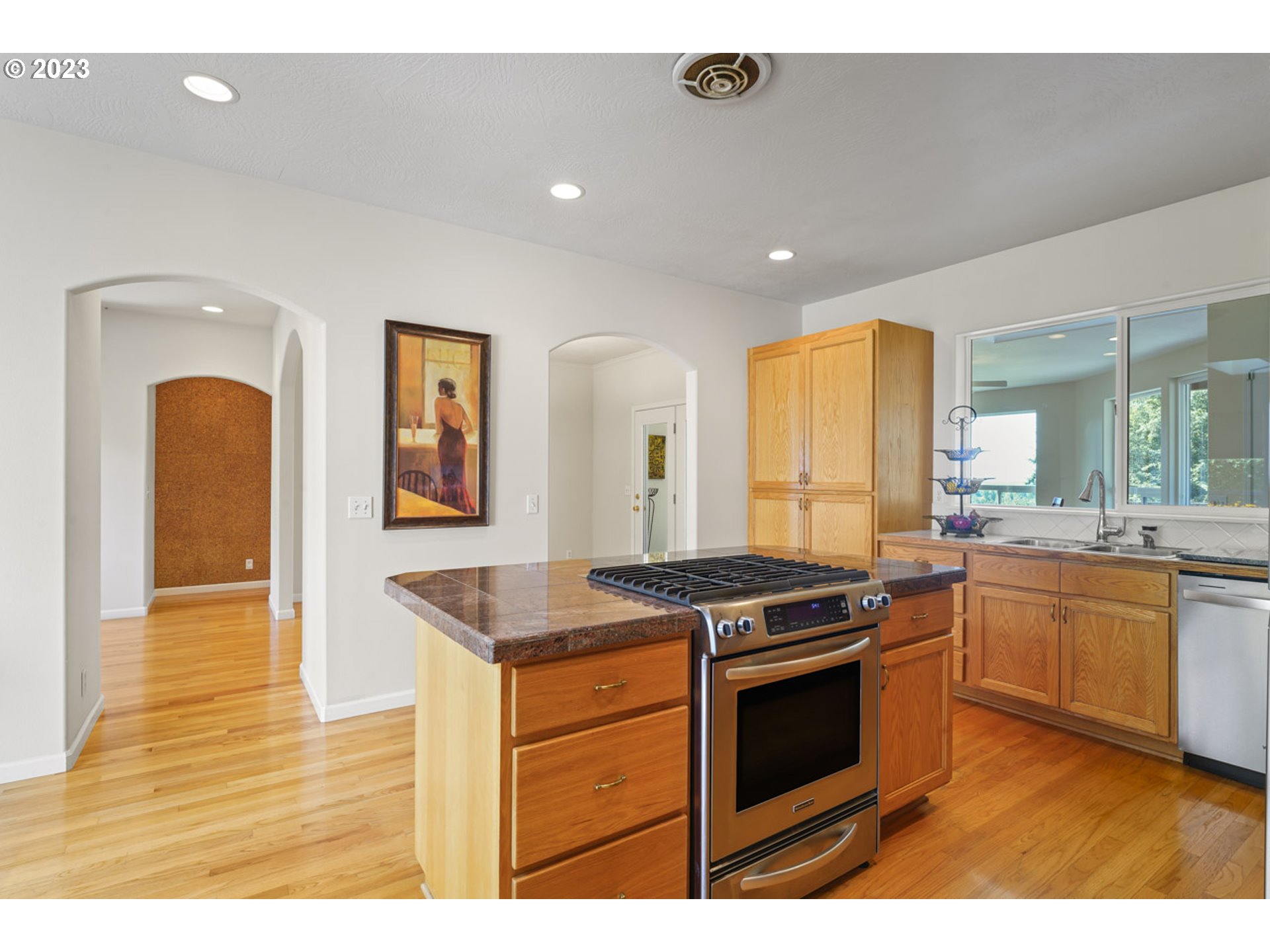 2920 Adams Street Eugene, OR 97405 - Photo 10 of 38 a kitchen with stainless steel appliances granite countertop a stove a sink and a refrigerator