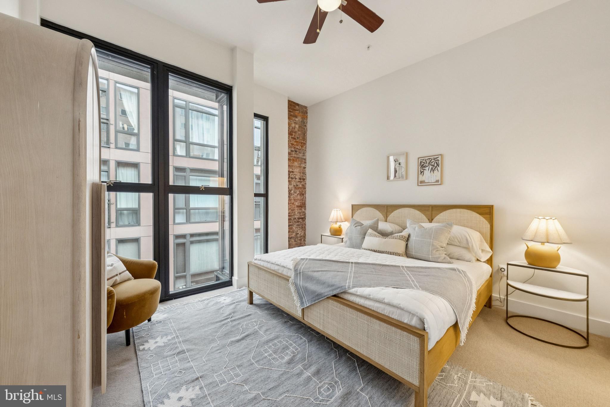 1209 13th Street Northwest, Unit 209 Washington, DC 20005 - Photo 12 of 16 a bedroom with a bed a couch and a window