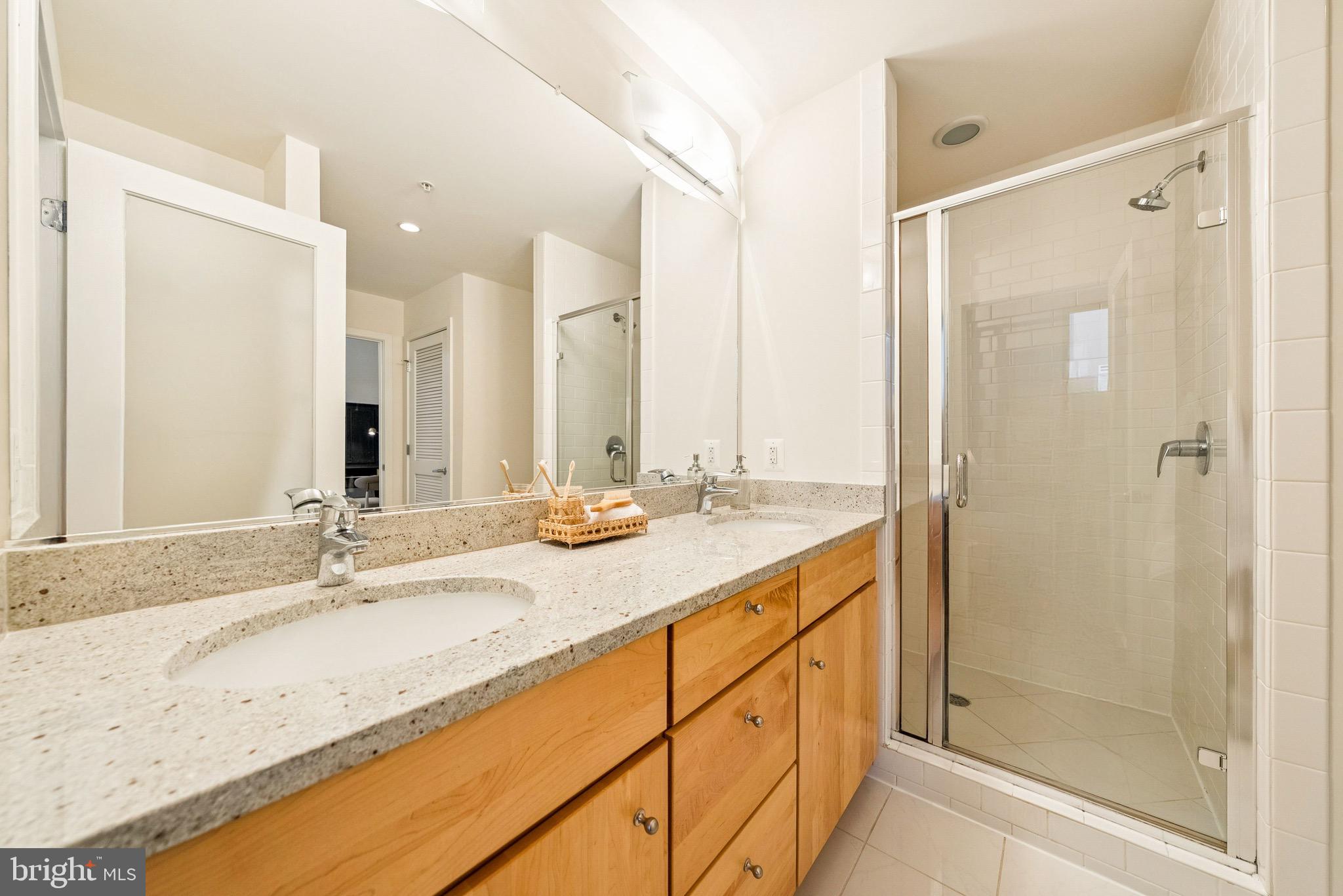 1209 13th Street Northwest, Unit 209 Washington, DC 20005 - Photo 14 of 16 a bathroom with a granite countertop sink mirror and double