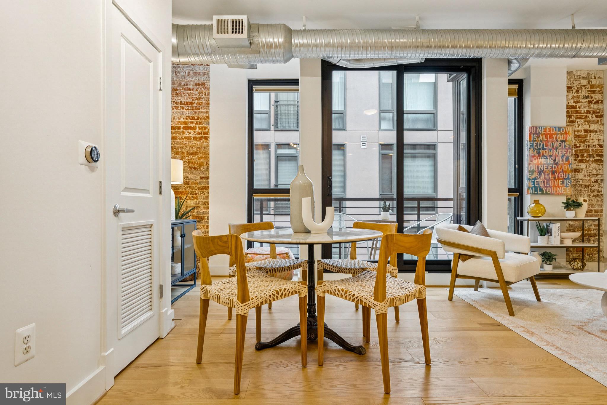 1209 13th Street Northwest, Unit 209 Washington, DC 20005 - Photo 5 of 16 a dining room with furniture and wooden floor