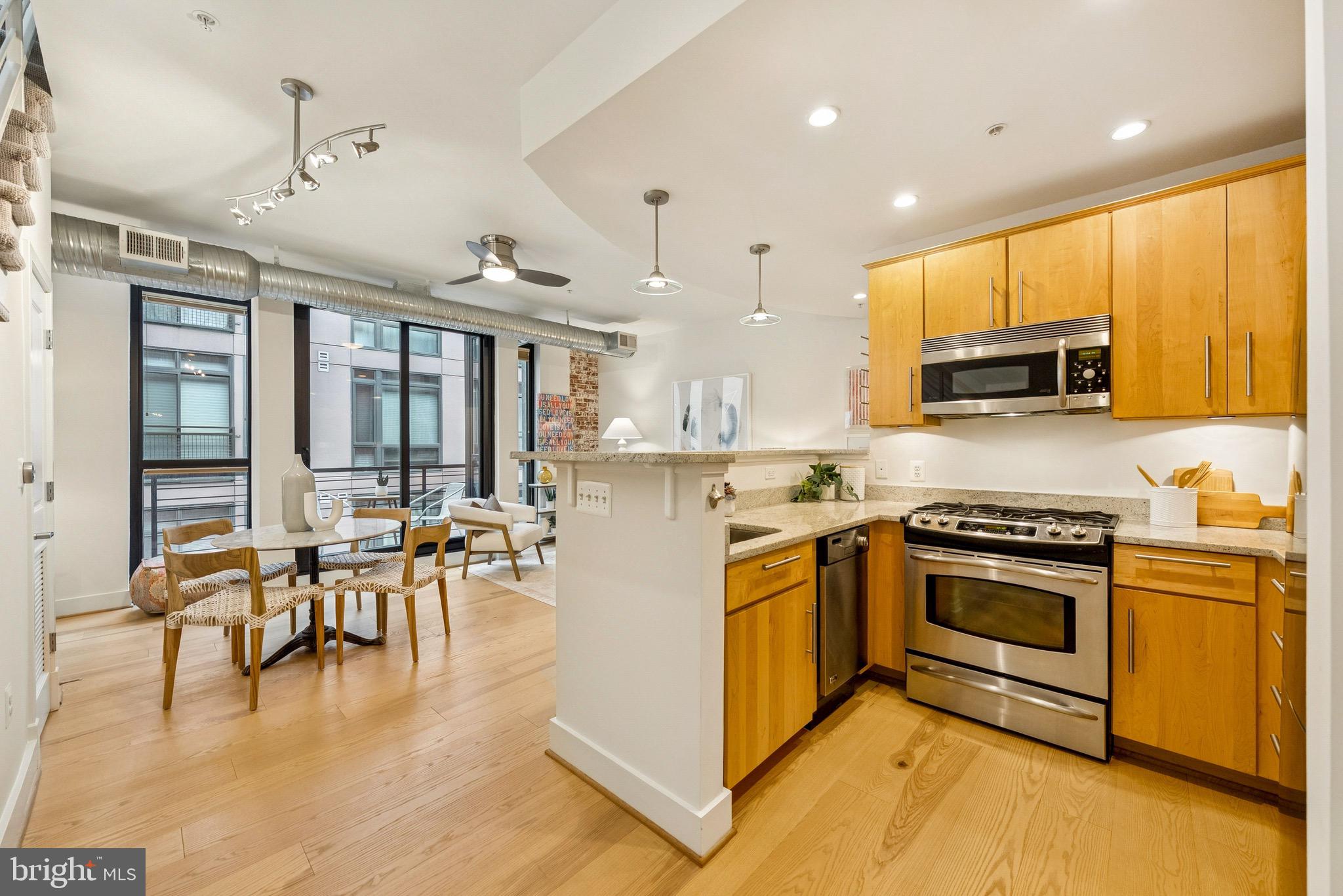 1209 13th Street Northwest, Unit 209 Washington, DC 20005 - Photo 8 of 16 a kitchen with stainless steel appliances granite countertop a stove and cabinets