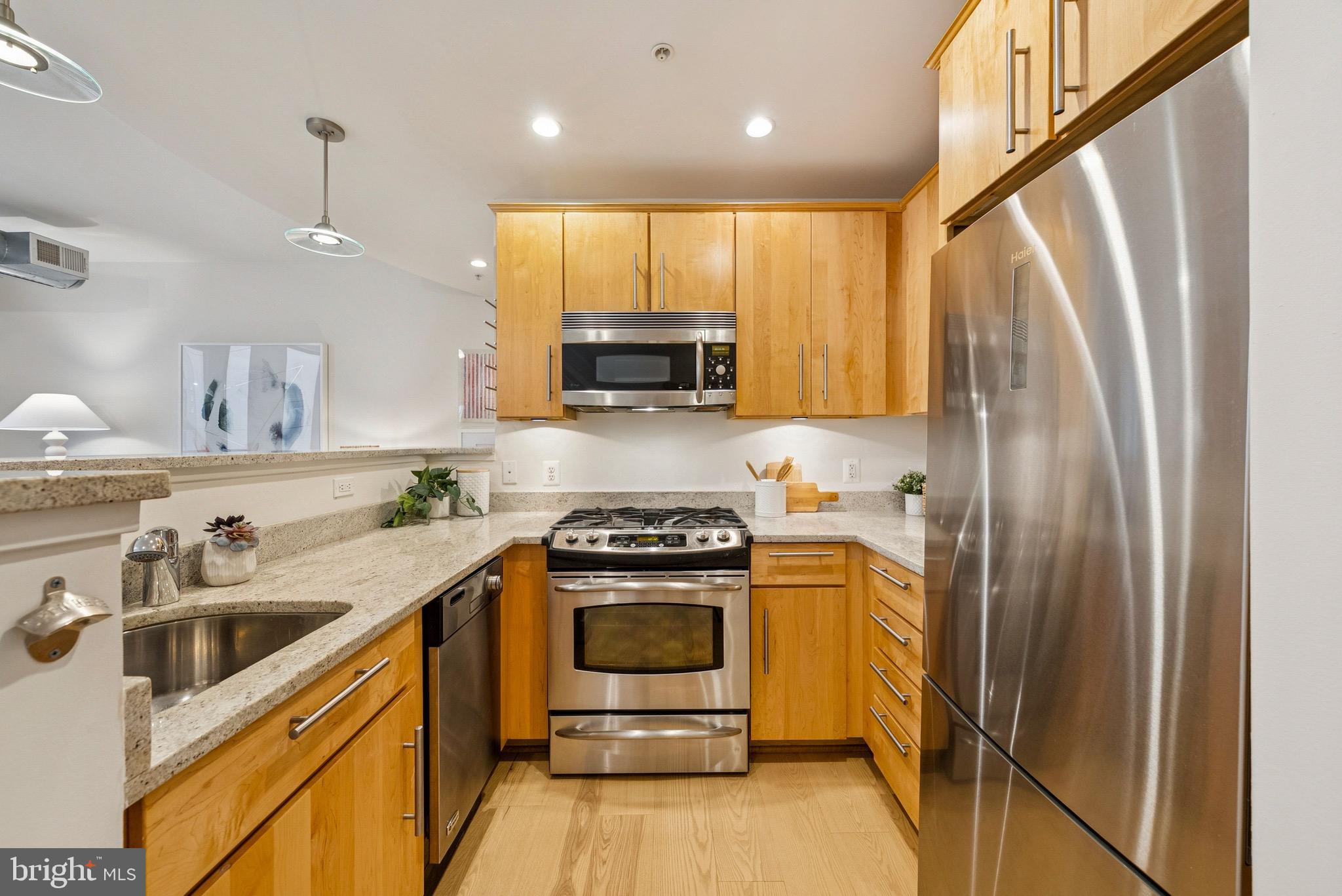 1209 13th Street Northwest, Unit 209 Washington, DC 20005 - Photo 9 of 16 a kitchen with a sink a stove and refrigerator