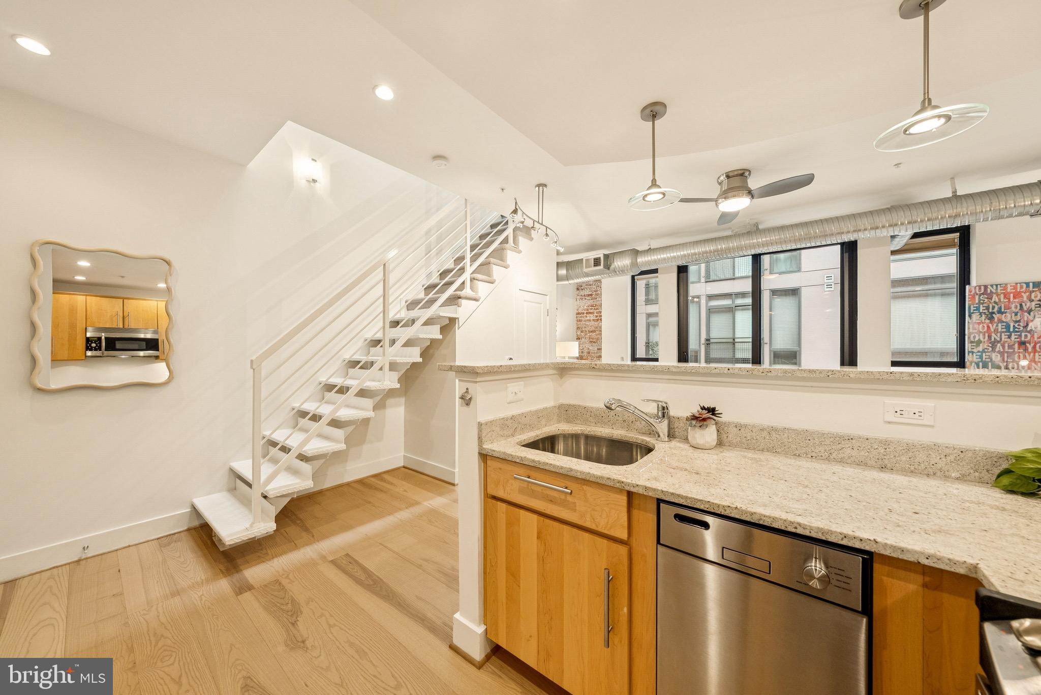 1209 13th Street Northwest, Unit 209 Washington, DC 20005 - Photo 10 of 16 a hallway with a sink a washer and dryer