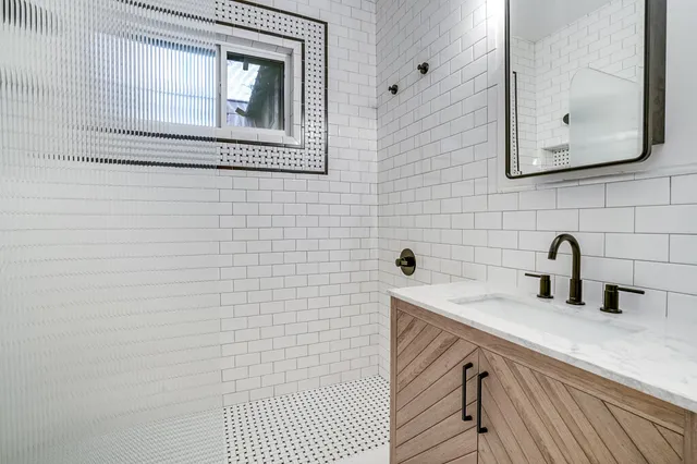 a bathroom with a sink a mirror and vanity