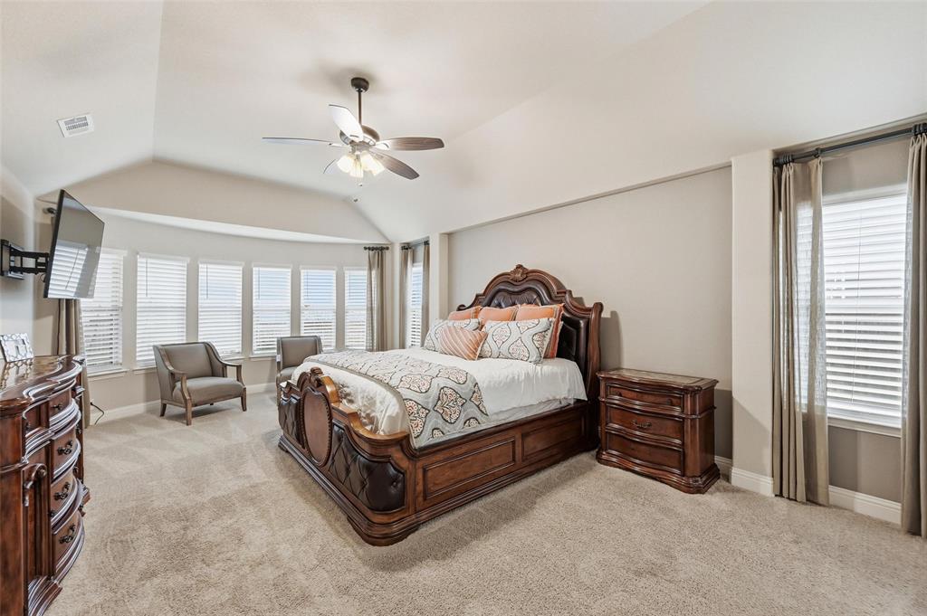 1421 Nighthawk Lane Mansfield, TX 76063 - Photo 18 of 40 a spacious bedroom with a bed and a chandelier