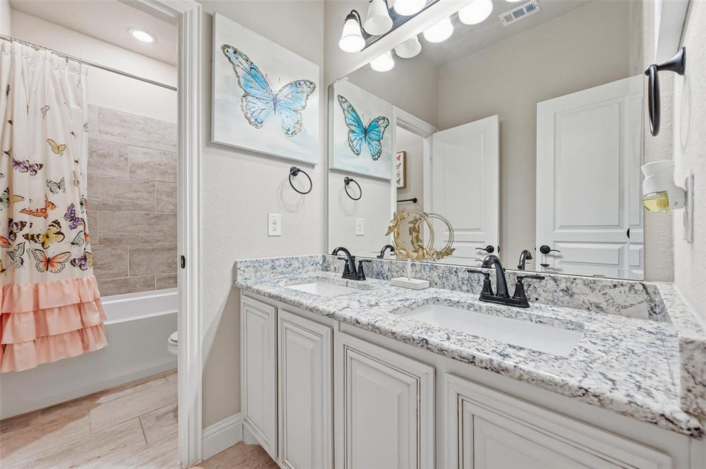 1421 Nighthawk Lane Mansfield, TX 76063 - Photo 26 of 40 a bathroom with a granite countertop sink and a mirror