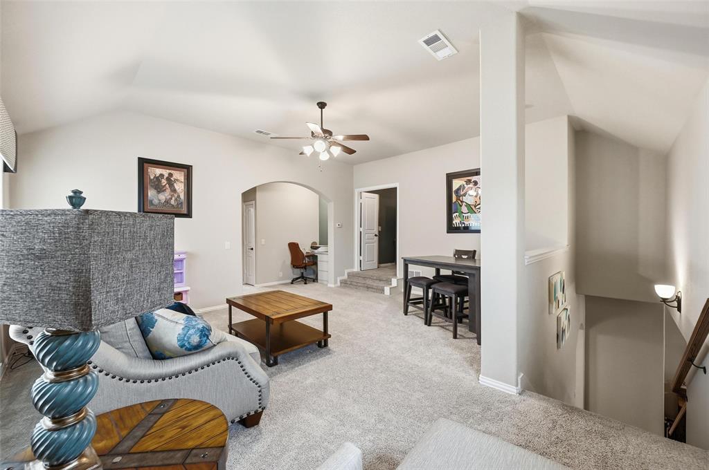 1421 Nighthawk Lane Mansfield, TX 76063 - Photo 28 of 40 a living room with furniture and a chandelier