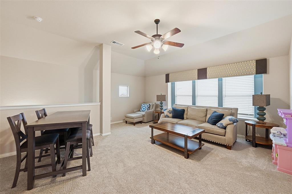 1421 Nighthawk Lane Mansfield, TX 76063 - Photo 29 of 40 a living room with furniture a fireplace and a large window